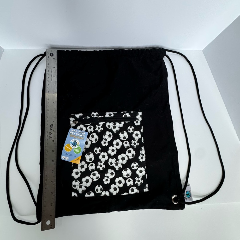 NWT Backpack Soccer themed and has a liner inside that will hold wet items.